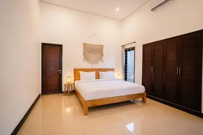a bedroom with a large bed in a room at Villa Kirari in Seminyak