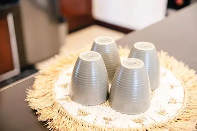 a group of white plates sitting on a table at Villa Kirari in Seminyak