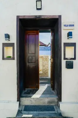 an open door to a white building with a door sidx sidx at Villa Kirari in Seminyak