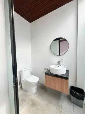 a bathroom with a toilet and a sink and a mirror at Oemah Ozzy Villa 2 Bedroom With Privat Pool in Seminyak