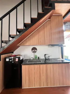 a kitchen with a sink and a staircase at Oemah Ozzy Villa 2 Bedroom With Privat Pool in Seminyak