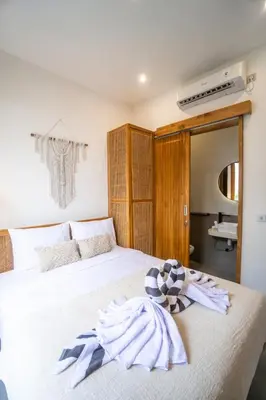 a bedroom with a white bed with a towel on it at NEW! Spring Villa - 2BR Villa in Kerobokan in Kerobokan