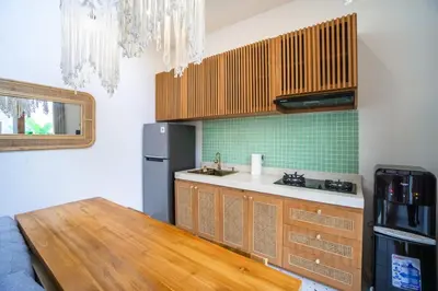 a kitchen with a sink and a refrigerator at NEW! Spring Villa - 2BR Villa in Kerobokan in Kerobokan
