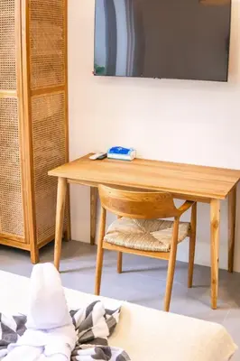 a wooden table and a chair in a room at NEW! Spring Villa - 2BR Villa in Kerobokan in Kerobokan