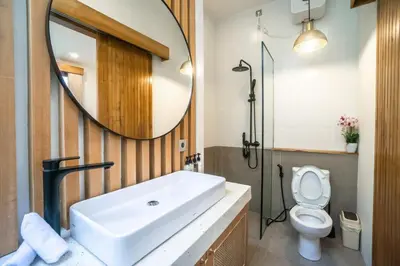 a bathroom with a sink and a mirror and a toilet at NEW! Spring Villa - 2BR Villa in Kerobokan in Kerobokan