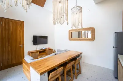 a dining room with a table and a tv at NEW! Spring Villa - 2BR Villa in Kerobokan in Kerobokan