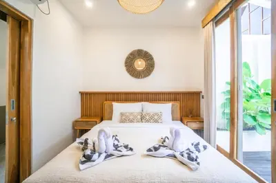 a bedroom with a bed with two towels on it at NEW! Spring Villa - 2BR Villa in Kerobokan in Kerobokan