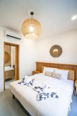 a bedroom with a bed with towels on it at NEW! Spring Villa - 2BR Villa in Kerobokan in Kerobokan