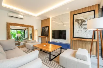 a living room with a couch and a table at Luxury 3BR Modern Villa in the Heart of Seminyak in Seminyak
