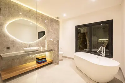 a bathroom with a tub and a sink and a mirror at Luxury 3BR Modern Villa in the Heart of Seminyak in Seminyak