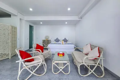 a bedroom with a bed and chairs and a table at Emilia 1 Bedroom Apartment Seminyak by Nagisa Bali in Kerobokan