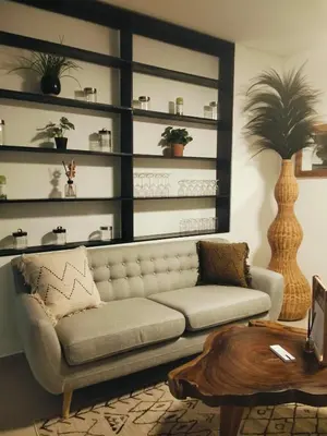 a living room with a couch and a table at Amshiga 2 in Jimbaran