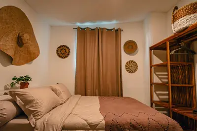 a bedroom with a bed and a book shelf at Amshiga 6 in Jimbaran