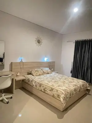 a bedroom with a bed and a desk and a chair at Studio with rice field view in Kerobokan in Kerobokan