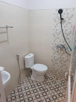 a bathroom with a toilet and a shower in it at Studio with rice field view in Kerobokan in Kerobokan