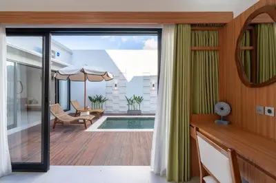 a view from the balcony of a house with a pool at Nirvana Villa by Betterplace in Seminyak