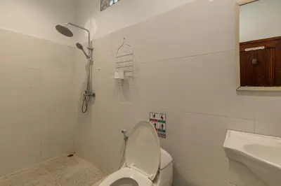 a bathroom with a toilet and a sink at Soma Villa by Betterplace in Jimbaran