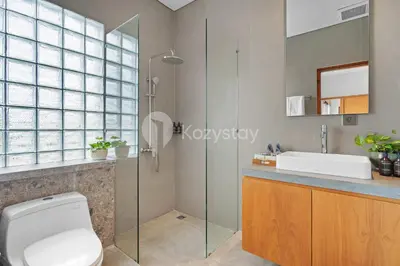 a bathroom with a shower and a toilet and a sink at deTasia Villa by Kozystay - Jimbaran in Jimbaran