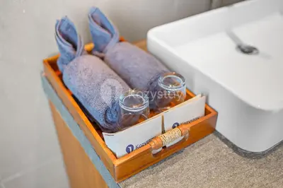 a wooden crate with glasses and towels next to a sink at deTasia Villa by Kozystay - Jimbaran in Jimbaran