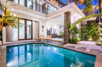 an indoor swimming pool in a house at Villa Naga by JB Villas in Seminyak