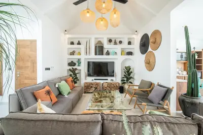 a living room with a couch and a tv at Villa ADDI 4bedrooms Oberoi in Seminyak
