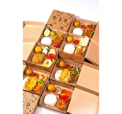 a pile of boxes filled with different types of food at Collection O Bali Sanur near Bali Mandara Hospital in Sanur