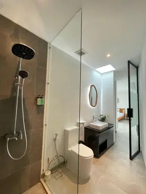 a bathroom with a shower and a toilet and a sink at Sunflower Bali Villa 3BR Legian Double Six Beach in Seminyak