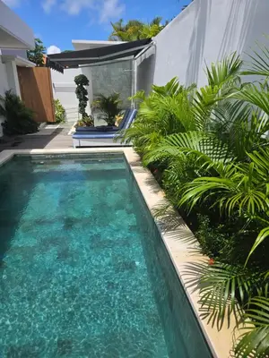a swimming pool in a yard with plants at Sunflower Bali Villa 3BR Legian Double Six Beach in Seminyak