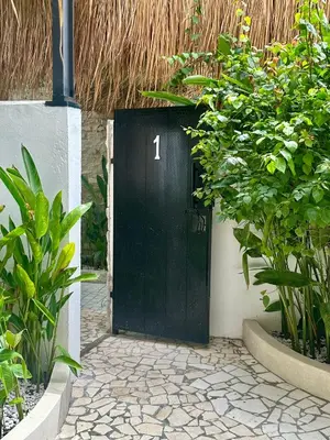a black door with the number one on it at Villa Vela in the heart of Seminyak in Seminyak