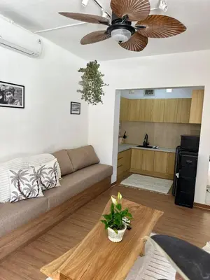 a living room with a couch and a ceiling fan at Villa Vela in the heart of Seminyak in Seminyak