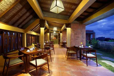 a restaurant with tables and chairs on a patio at The Visala Boutique Suites Seminyak in Seminyak
