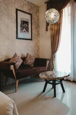 a living room with a couch and a table at The Visala Boutique Suites Seminyak in Seminyak