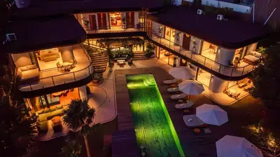 an aerial view of a building at night with a green light at Dreamtime House Bali in Canggu
