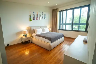 a bedroom with a bed and a large window at Lillypad 5Bed Villa in Seminyak