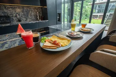 a table with a plate of food and drinks at Lillypad 5Bed Villa in Seminyak