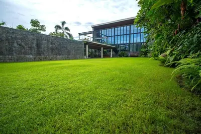 a large grass field in front of a building at Lillypad 5Bed Villa in Seminyak