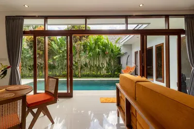 a living room with a view of a pool at Villa Suka Damai Peaceful 2 Bedroom Getaway in Seminyak