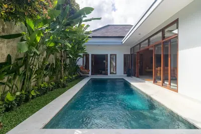 an infinity pool in the backyard of a house at Villa Suka Damai Peaceful 2 Bedroom Getaway in Seminyak