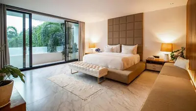 a bedroom with a large bed and a large window at House of Light 5bed villa in Canggu