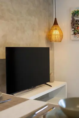 a flat screen tv sitting on top of a table at Harmoni Lane Studios in Seminyak