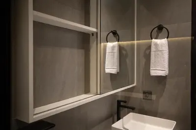 a bathroom with a sink and a mirror at Harmoni Lane Studios in Seminyak