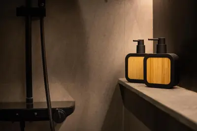a bathroom with two soap dispensers on a counter at Harmoni Lane Studios in Seminyak