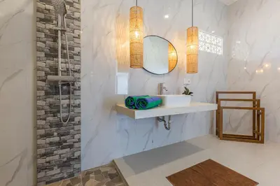 a bathroom with a sink and a shower at VILLA BIBA cosy and stylish in Canggu