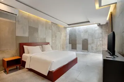 a bedroom with a bed and a flat screen tv at Aqilah Villa Bali in Legian