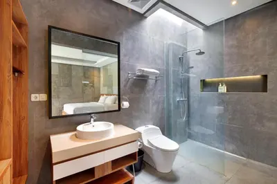a bathroom with a toilet and a sink and a shower at Aqilah Villa Bali in Legian