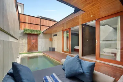 a living room with a swimming pool in a house at Aqilah Villa Bali in Legian