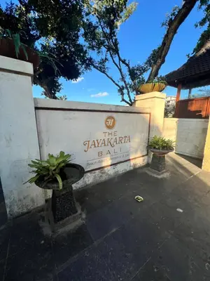 a sign for the savannah park with two potted plants at Apartment at Jayakarta Residence Beach Front Access in Seminyak