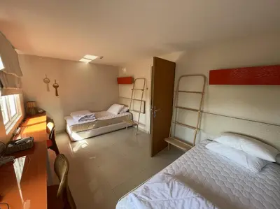 a bedroom with two beds and two bunk beds at Apartment Keluarga di Kuta Bali in Kuta