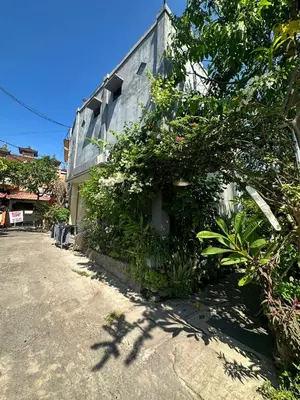 a building with plants on the side of it at Sari Buana Bed & Breakfast in Kuta