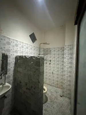 a bathroom with a toilet and a sink at Sari Buana Bed & Breakfast in Kuta